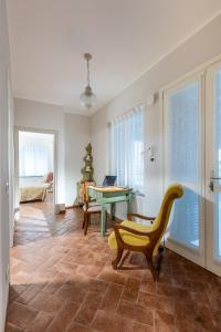 a living room with a table and a chair at Nidin Apartments in Cassano Spinola
