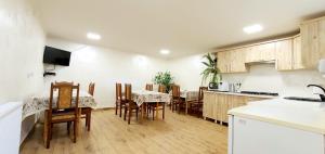 a kitchen and dining room with a table and chairs at Гуцульська оселя in Yaremche +16 photos