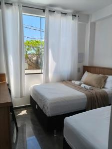 Postel nebo postele na pokoji v ubytování suíte 17 dupla praia de leste