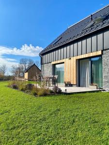 a barn with a picnic table in front of it at Nad Soutokem in Volary