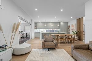a living room with a couch and a table at Bundeena Bungalow in Bundeena