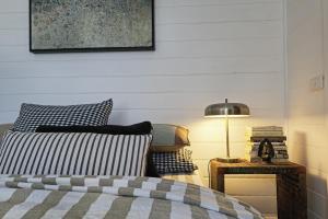 a bedroom with a bed and a table with a lamp at Sage in Glenlyon