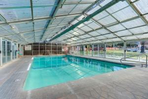 a large swimming pool with a glass ceiling at Riverfront Studio in Downtown Bend in Bend