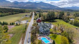an aerial view of a home with a pool and mountains at Franconia Inn in Franconia