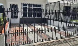 a black fence in front of a house at Aparta estudio Luxury in Cali