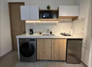 a small kitchen with a dishwasher and a sink at Aparta estudio Luxury in Cali