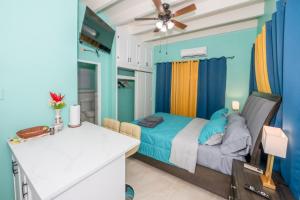 a bedroom with a bed and a white counter at J & B Studio Apartment in Saint Johnʼs