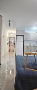 a room with a bed and a table in it at The beach nest in Candelaria