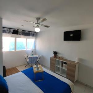 a bedroom with a bed and a tv on the wall at The beach nest in Candelaria