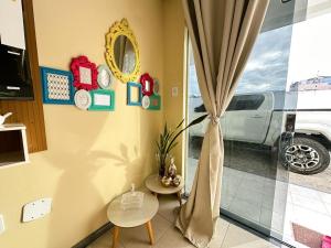 a living room with a window with a truck outside at Condomínio Orla de Atalaia in Aracaju