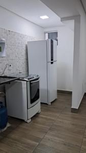 een keuken met een fornuis en een koelkast bij Dima's in Porto Seguro