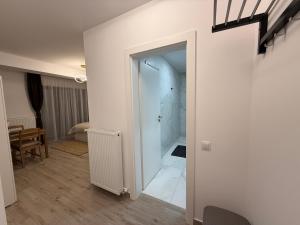 a hallway with a glass door leading to a bedroom at The View Studio 2 Busteni in Buşteni