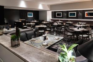 a restaurant with tables and chairs in a room at Crowne Plaza Auckland by IHG in Auckland