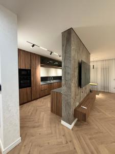 ein Wohnzimmer mit einem TV und Holzböden in der Unterkunft Luxury Penthouse in Ferizaj