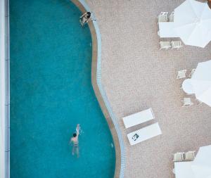 an overhead view of a man standing in a swimming pool at Muong Thanh Grand Nha Trang Hotel in Nha Trang