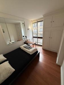 a bedroom with a bed and a large mirror at Trocadero in Paris