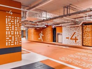 an empty room with orange walls and a floor with writing on it at Towarowa Towers SkyLine in Warsaw
