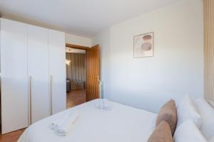 a bedroom with a large white bed and a room at Bardonecchia Campo Smith 3 in Bardonecchia +11 photos