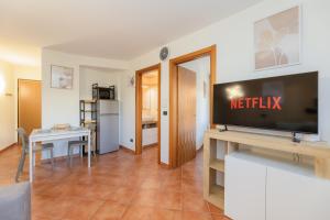 a living room with a television and a dining room at Bardonecchia Campo Smith 3 in Bardonecchia