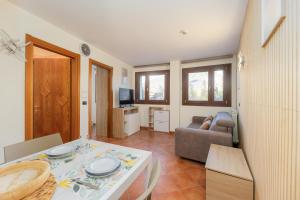 a living room with a table and a couch at Bardonecchia Campo Smith 3 in Bardonecchia