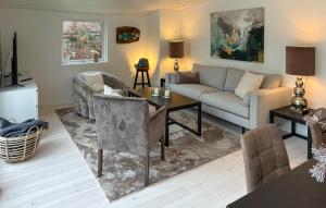 ein Wohnzimmer mit Sofa und Tisch in der Unterkunft Beautiful Home In Dronningmølle With Wifi in Hulerød