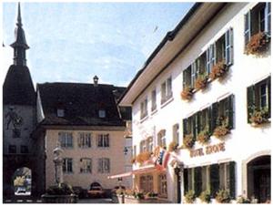 a building with a clock tower in a town at Hotel Krone in Wangen an der Aare