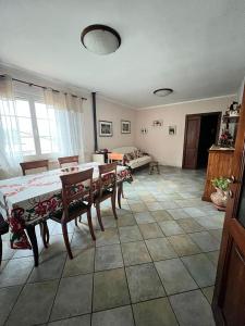 a living room with a table and chairs and a couch at Villa Giulia in Ateleta +21 photos