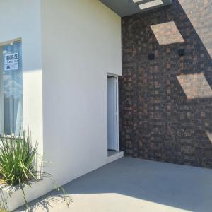 a building with a window and a brick wall at Casa 1 Montebelle in Porangaba +4 photos