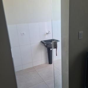 a bathroom with a sink in a stall at Casa 1 Montebelle in Porangaba