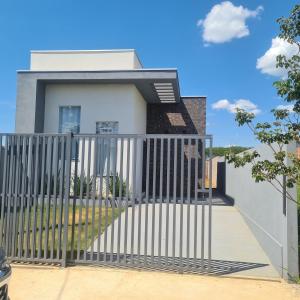 a house with a gate in front of it at Casa 1 Montebelle in Porangaba