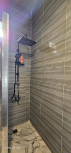 a shower with a wooden wall with a light on it at Jerash City View in Jerash +197 photos