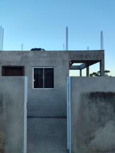 a building with two doors in front of it at Loft Praia da Vila in Imbituba +1 photo