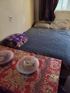 a room with two beds and two plates on the floor at Loft Praia da Vila in Imbituba