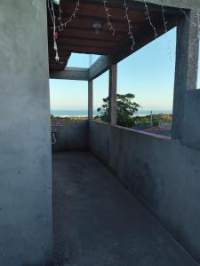 an empty room with a view of the ocean at Loft Praia da Vila in Imbituba
