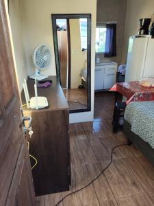 a room with a bedroom with a mirror and a bed at Loft Praia da Vila in Imbituba