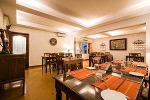un comedor con muchas mesas y sillas en Tissa's Inn, en Kochi