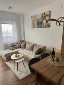 a living room with a couch and a table at Cozy apartment Banja Luka in Budžak