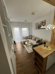 a living room with a couch and a table at Cozy apartment Banja Luka in Budžak