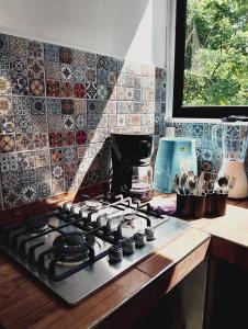 a stove top in a kitchen with a tile wall at Posada Casa Tortuga, Zipolite in Zipolite +71 photos