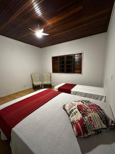 En eller flere senge i et værelse på Chácara Eco Ville