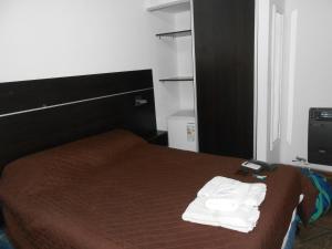 een slaapkamer met een bed met twee handdoeken erop bij Apart Hotel Los Angelitos in Federación