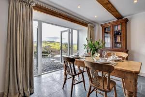 a dining room with a table and chairs and a large window at 2 Bed in Machynlleth oc-bow39 in Darowen