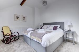 a bedroom with a large bed and a chair at 2 Bed in Machynlleth oc-bow39 in Darowen