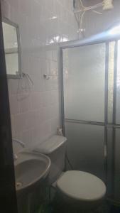 a bathroom with a toilet and a sink at Panga Loft in Abraão +4 photos