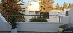 a balcony with a view of a white building at Résidence Debbabi in Monastir