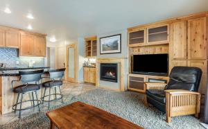 a living room with a tv and a fireplace at Rustic Pet-Friendly Second Floor Condo in Bend