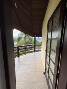 an open door of a house with a balcony at Interior beach house in Bombinhas! in Bombinhas