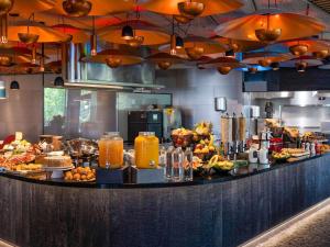 a buffet line in a restaurant with food and drinks at Ibis Styles Madrid City Las Ventas in Madrid
