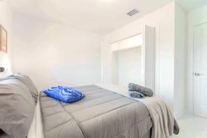a bedroom with a bed with blue bags on it at Prime Location Duplex with Free Parking in Miami +8 photos