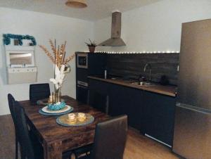 a kitchen with a wooden table and a kitchen with a sink at O Caminho Azul in Olivenza
